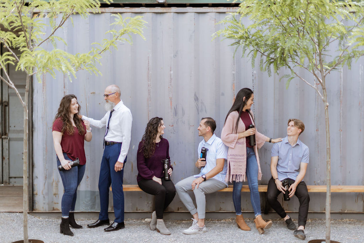 Beautiful women talking to well dressed men on a bench